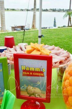 there is a sign that says ham's ham and cheese next to some food