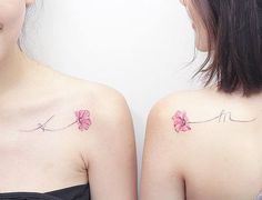 two women with tattoos on their backs and one has a pink flower tattooed on her left shoulder