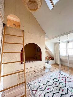 a room that has a ladder in the middle of it and a rug on the floor