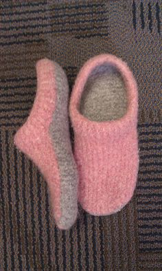 two pairs of pink and grey slippers on carpet