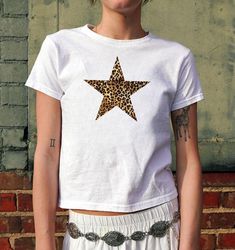 🐆 Leopard Print Star Baby Tee 🐆 Leopard Print Star Baby Tee | Retro Graphic Print 90s Shirt Leopard TShirt Downtown Girl Boho Y2K Aesthetic Trendy Animal Pattern Print TeeGraphic 90s Tshirt Gift For Her 90s Baby Tee, Y2K Clothing, Gift for Her, Tropical Summer Shirt | 90s Aesthetic Clothing | Cute Summer Downtown Girl Top | Floral Tshirt | Y2K Clothing | Animal Graphic Tee | Vintage Style Top | Women's Tee |  2000s Trendy Top | Retro Graphic Shirt | Y2K Fitted Baby Tee ✨ FABRIC CONTENT Made wi Trendy Summer T-shirt With Star Patch, Summer Cotton T-shirt With Star Patch, Cute Short Sleeve T-shirt With Star Print, Trendy Star Print Tops For Streetwear, Trendy Tops With Star Print For Streetwear, Cotton Graphic Tee With Star Patch, Y2k Star Print Tops For Streetwear, Summer Star-shaped Graphic Tee, Summer Star Shaped Graphic Tee