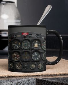 a black coffee mug with different types of clocks on the inside and outside of it