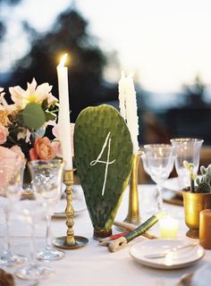 the table is set with candles and flowers