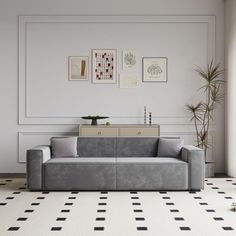 a modern living room with black and white checkered flooring, gray couch, potted plant and pictures on the wall