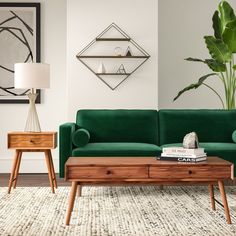 a living room with a green couch and two side tables in front of it,