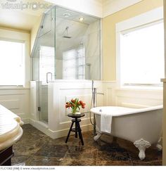 a bathroom with a tub, sink and shower