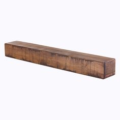 a wooden shelf sitting on top of a white wall