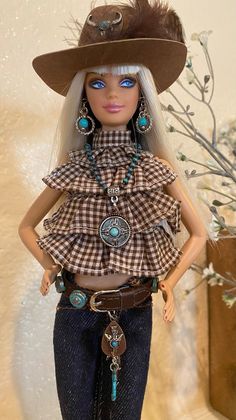 a barbie doll wearing a cowboy outfit and hat with feathers on it's head