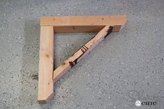 a wooden frame sitting on top of a cement floor