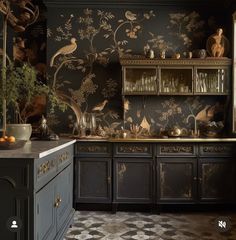 the kitchen is decorated in black and gold with birds on the wall behind the cabinets