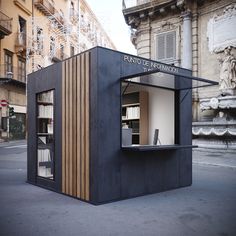 a small black building with wooden slats on the outside