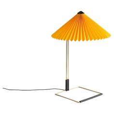 Designed by Inga Sempé, the Matin Table Lamp offers a contemporary yet poetic design, with a construction that combines visual delicacy with physical robustness. It consists of a steel wire bent frame finished in polished brass with matte black hardware and is paired with a pleated cotton shade in a variety of vibrant colors. The light source is an integrated LED, offering a diffused light which is accompanied by a digital in-line dimmer control to adjust the output of light if required. Size: H Lamp Large, Hay Design, Matte Black Hardware, Contemporary Table Lamps, Table Lamp Design, Design Within Reach, Desk Lamps, Diffused Light, Dimmer Switch