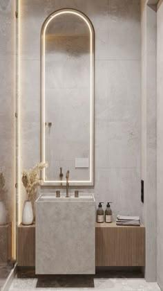 a bathroom with a sink, mirror and lights on the wall above it's counter