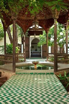 an outdoor area with green and white tiles