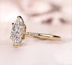 a close up of a diamond ring on a table