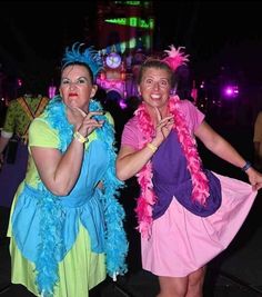 two women dressed in costumes posing for the camera