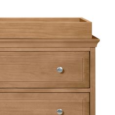 a wooden dresser with three drawers and two knobs