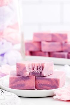 some pink soaps on a white plate