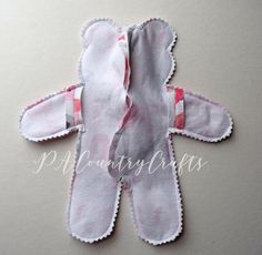 a pair of pink and white mittens laying on top of each other