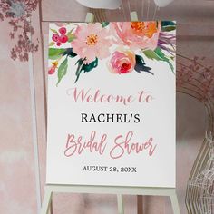 a welcome sign for a bridal shower with flowers on it and balloons in the background