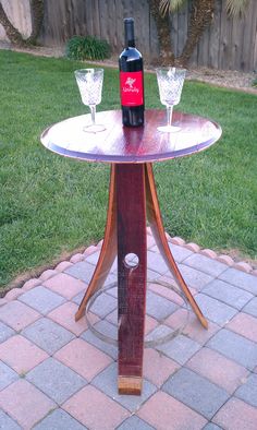 two wine glasses sitting on top of a wooden table next to a bottle of wine