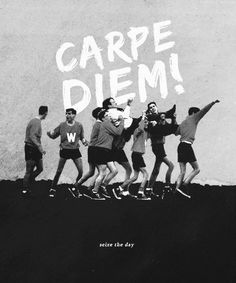 a group of people standing in front of a wall with the words carpe diem written on it