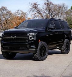 a large black truck parked in a parking lot