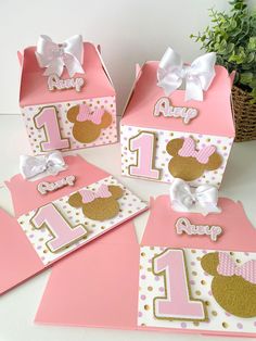 pink and gold minnie mouse birthday party treat boxes with polka dots, bows and numbers