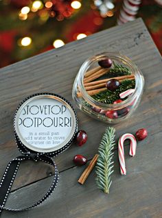 an assortment of candy canes and candies on a wooden table with christmas decorations