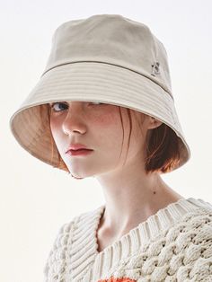 a woman wearing a white hat and sweater