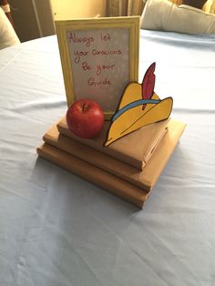 an apple sitting on top of two wooden boards