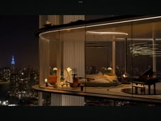 a bedroom with a view of the city lights at night from an elevated room in a skyscraper building