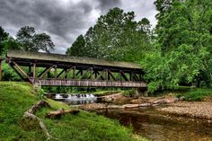 a wooden bridge over a stream in the woods