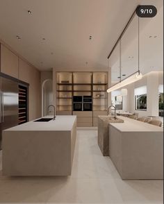 a modern kitchen with an island countertop and built - in wine cooler, oven and refrigerator