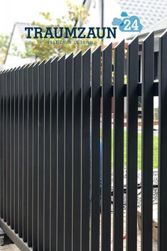 a black metal fence with the words traumzaun on it and an image of