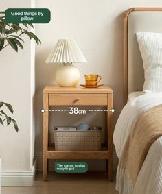 a bedroom with a bed, nightstand and plant on the side table next to it