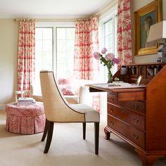 a living room filled with furniture and a window covered in red draping next to a dresser