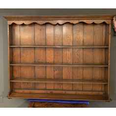 an old wooden bookcase with scalloped edges