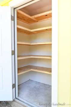 an empty closet with shelves in the corner and doors open to reveal another room that has been painted yellow