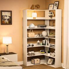 a white book shelf in the corner of a room