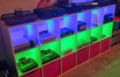 there are many electronic devices on the shelves in this room, all lit up with green and blue lights