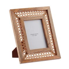 a wooden frame with an intricate design on the front and sides, holding a white background