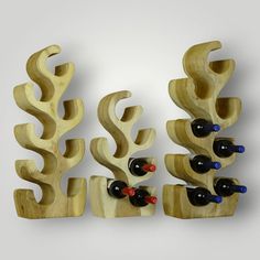 three wooden wine racks with bottles in them on a white background, one is made out of wood and the other two are shaped like corals