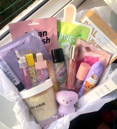 a basket filled with lots of different types of items next to a window sill