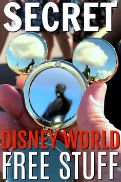 someone holding up a mickey mouse mirror with the words disney world free stuff on it