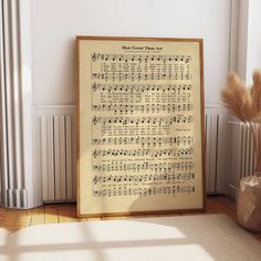 an old sheet music score is displayed in front of a vase with dried grass and a plant