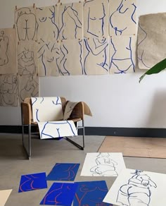 a chair sitting on top of a floor covered in blue and white paper cut outs