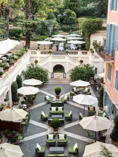 an outdoor courtyard with tables and umbrellas