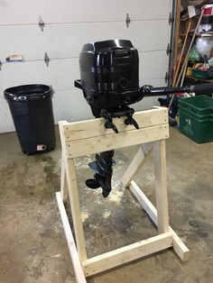 a motor on a wooden stand in a garage