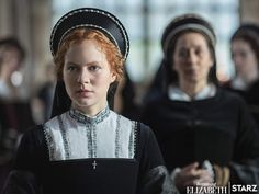 two women dressed in black and white standing next to each other